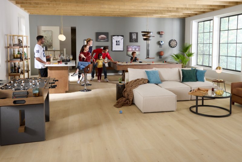 Family playing pool in a stylish rec room with Pergo flooring